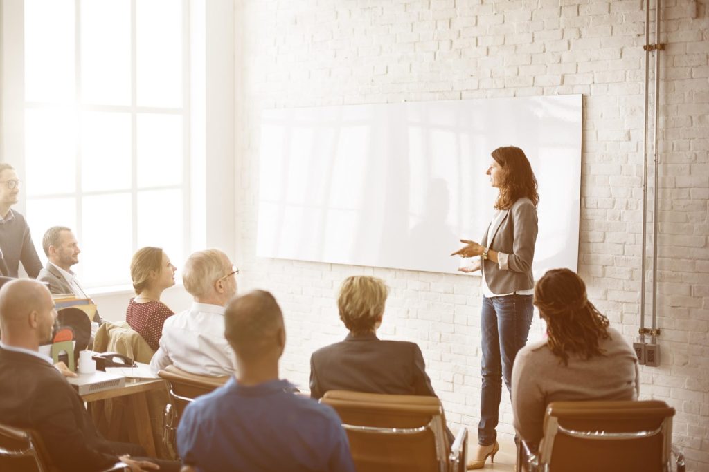 Professional lady giving presentation to audience